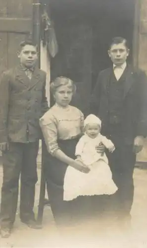 Social history anonymous persons portrait souvenir peasant family elegant clothes in the yard