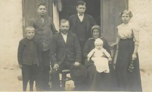Social history anonymous persons portrait souvenir peasant family elegant clothes in the yard