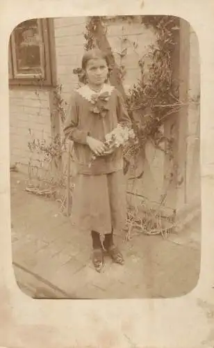 Social history anonymous persons portrait souvenir girl in the yard