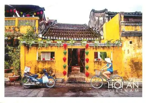 Vietnam Hoi An guy riding bicycle and motorcycle