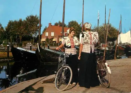 Netherlands Spakenburg (Utrecht) women in typical clothing with bicycles small talk