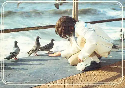 Belgium falaise girl feeding pigeons