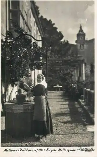Spain Mallorca Valldemosa ethnic woman carrying water from well
