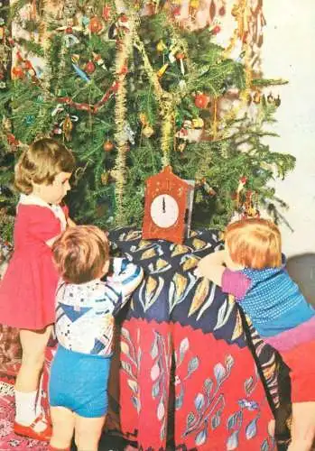 New Year's greetings children types around decorated tree