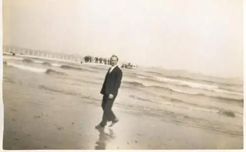 Real photo postcard place to identify man seaside