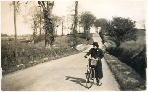 Real photo postcard place to identify elegant woman bicycle