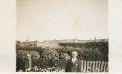 Real photo postcard place to identify elegant man garden