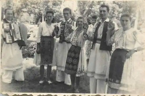 Anonymous person souvenir photo folk costume dancers