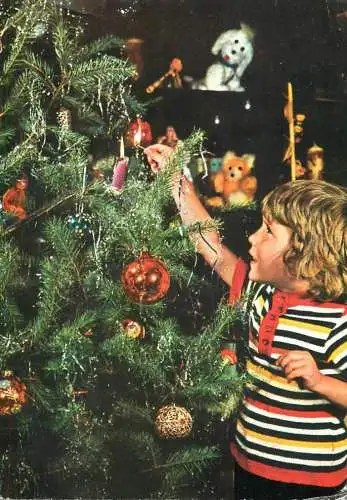 Young boy decorating Christmas tree