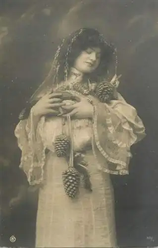 Fancy portrait woman white dress and tree cones