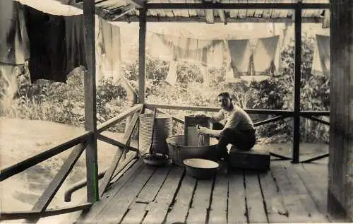 British social history souvenir photo man washing clothes on the porch