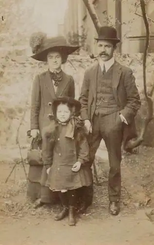 British social history souvenir photo elegant couple and daughter hats pipe