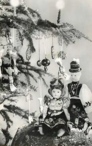 Christmas greetings decorated tree partial view & dolls with traditional costumes