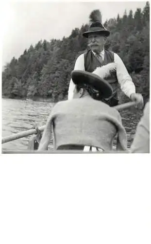 Men portrait vintage photo postcard traditional costume and hat with feather on a row boat