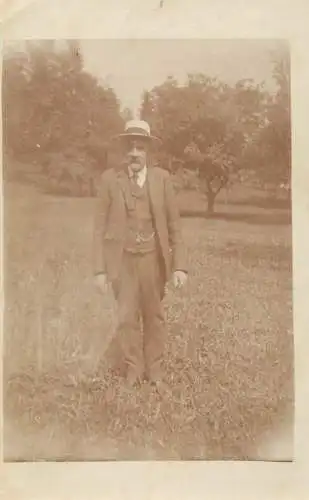 Men portrait vintage photo postcard elegant man with hat in orchard