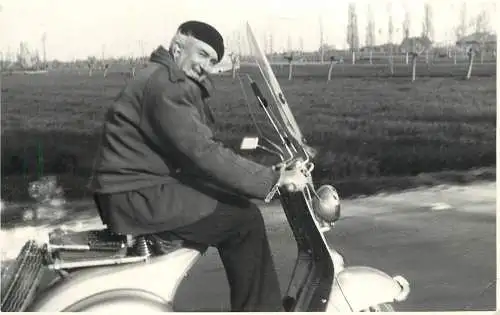 Social history photo elderly man on a Vespa