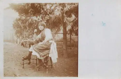 Postcard woman in traditional costume in the yard