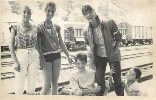 Postcard young teenagers playing in the train station