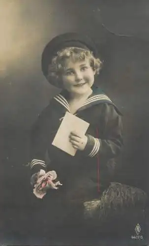 Postcard photograph of child posing with navy costume and envelope