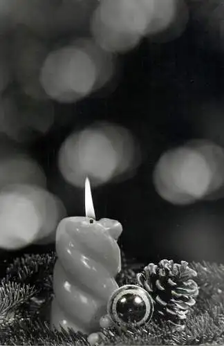 Christmas greetings lit burning candle detail