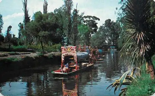 Mexico Xochimilco flower-decked boats with tourists along canals