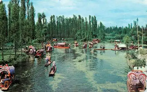 Mexico Xochimilco flower-decked boats with tourists along canals through Xochimico's gardens