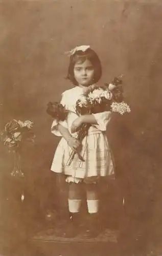 Elegant beautiful young girl wearing white dress with flower bouquet
