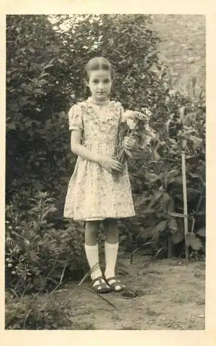 Social history real photo young girl with flower bouquet in garden