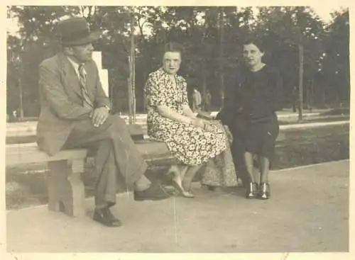 Real photo social history gentleman and ladies sitting on bench in park