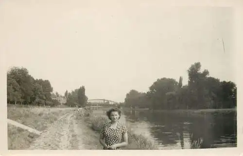 Real photo woman on river banks