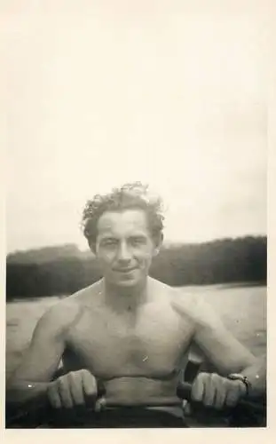 Real photo shirtless man rowing