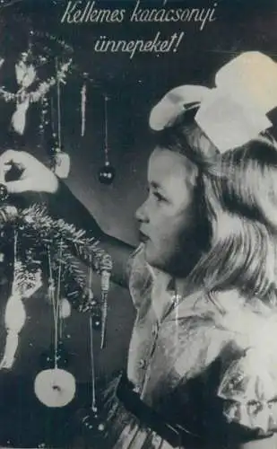 Christmas greetings young girl decorating fir tree