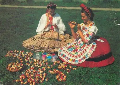 Easter Happy Holidays greetings ethnic types women painting eggs traditional costumes