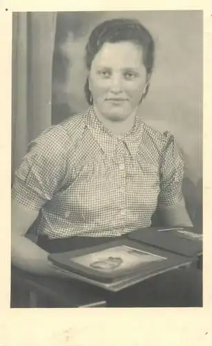 Vintage studio photography atelier photographers anonymous person woman browsing photo album