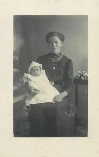 Vintage atelier studio photography anonymous person mother with her little baby family portrait picture