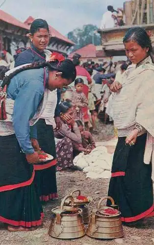 Postcard Nepal typical women from Kathmandu valley preparing for worship