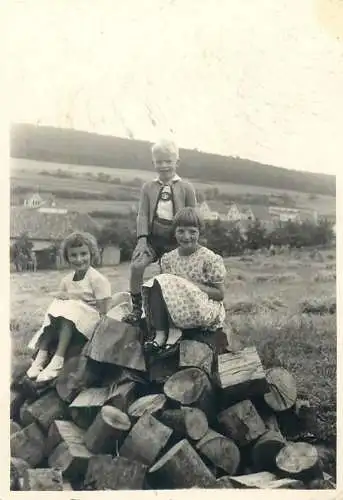 Photo ca. 7 x 10 cm children playing on top of firewood