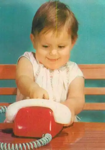 Post card cute little child making a phone call on telephone toy funny picture