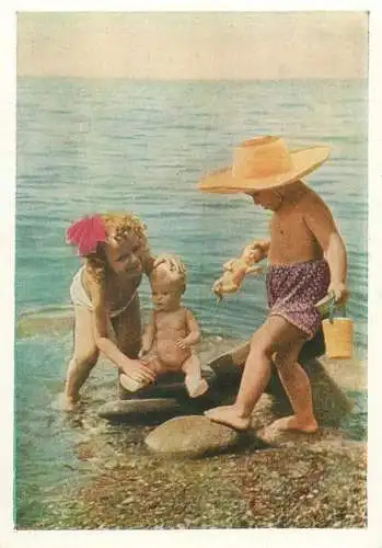 Postcard young boy and girl playing on the beach