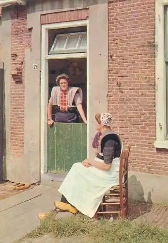 Postcard Dutch types and scenes women talking at the door typical costumes