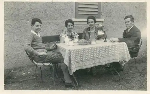 real photo social history memory Postcard family picture at the table outdoor scene detail view
