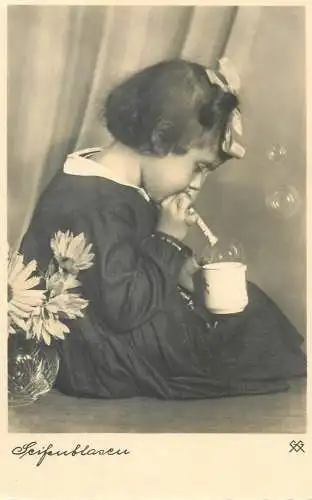 Postcard cute young girl making soap bubbles fancy ribbon hairstyle