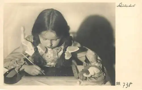 Postcard young schoolgirl writing on small blackboard
