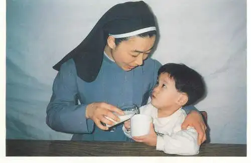 Postcard nun with young boy ethnic types an scenes