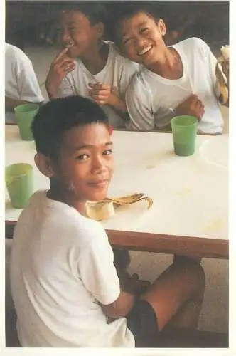 Postcard young school children ethnic types at the canteen