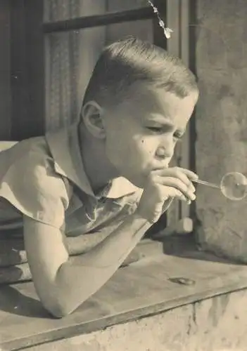 Post card young boy making water soap balloons