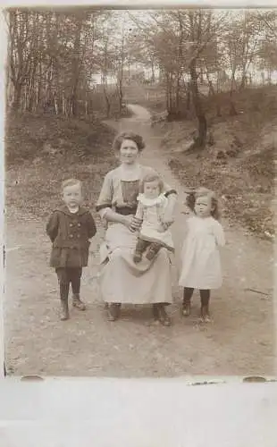 Postcard mother with her daughters and son family group photo outdoor scenery countryside dirt road