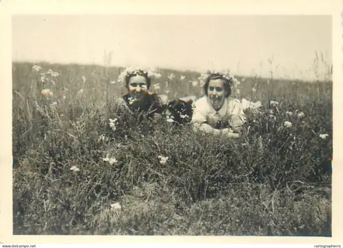 Anonymous persons girls flowers field souvenir photo