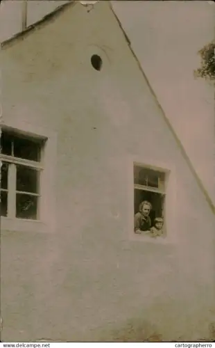 A5926 Photographic postcard two people, an adult and a child, looking out the window
