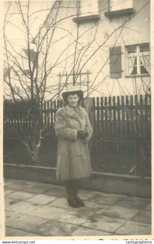 A5941 Anonymous young woman wearing a 1940s-style fur coat and hat photographic postcard